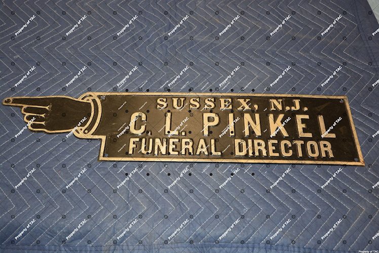 C.L. Pinkel Funeral Director pointing sign
