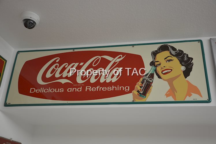 Coca-Cola Delicious and Refreshing with lady holding bottle