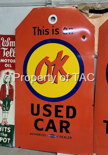 This is an OK Used Car Porcelain Sign (tag shaped)