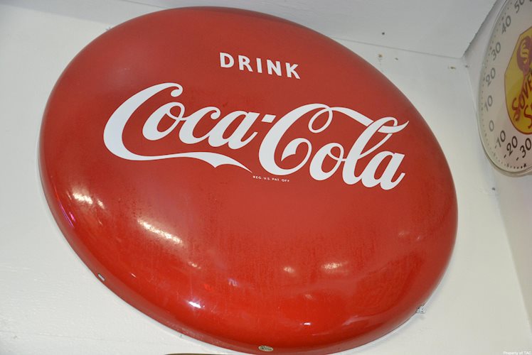 Coca-Cola button sign
