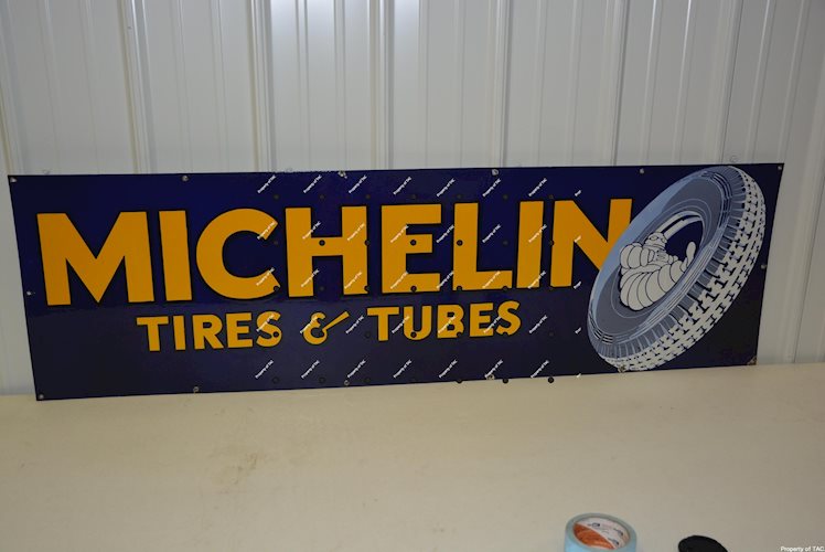 Michelin (tire) w/Bibendum sitting in a tire porcelain sign