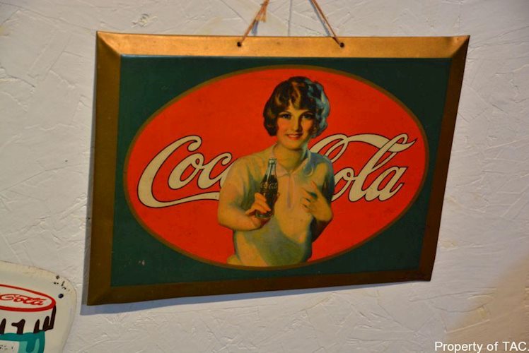 Coca Cola w/lady handing a bottle sign