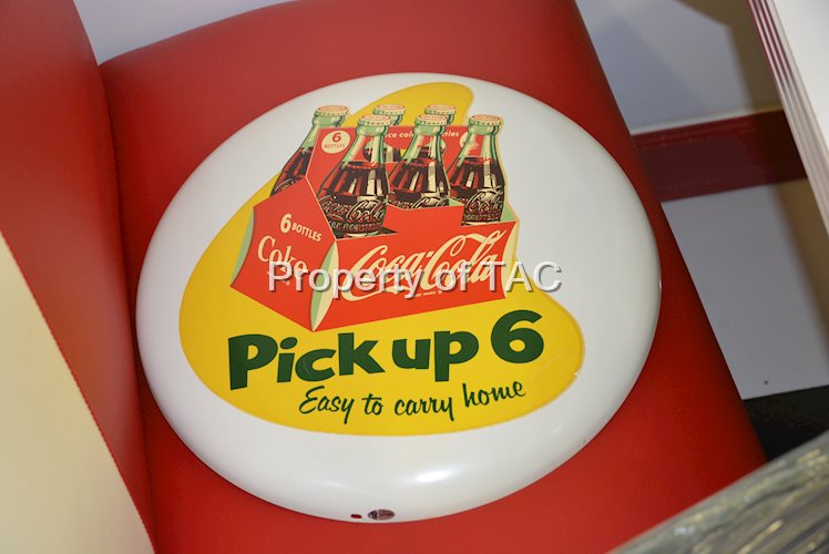 Coca-Cola button with "Pick up 6" decal,