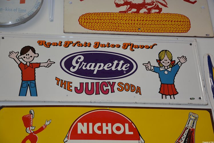 Grapette The Juicy Soda" sign"